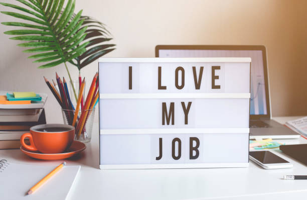 I love my job concepts with text on light box on desk table in home office stock photo