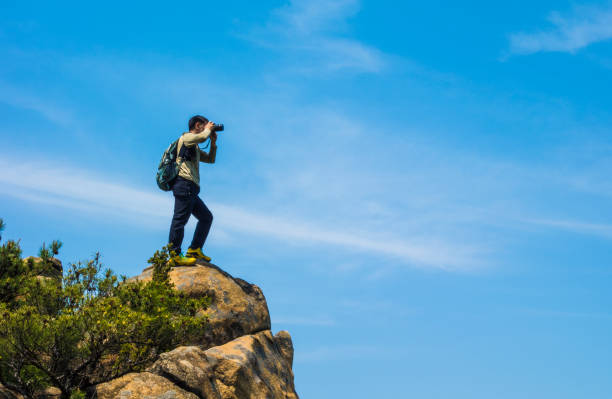 istock A photographer takes a picture on a rock 1154515906