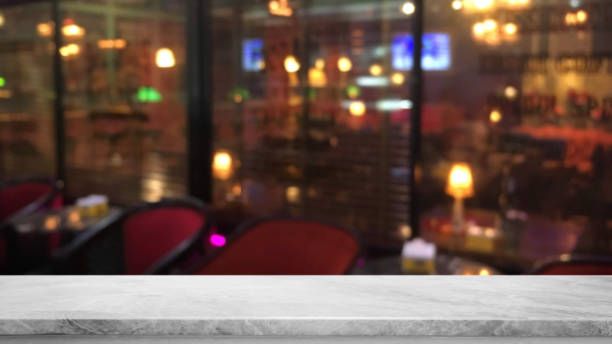istock Empty white mable stone table top on abstract blurred restaurant and nightclub lights background - can be used for display or montage your products 1154516779