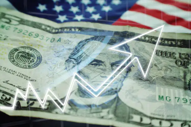 Photo of Business & Finance Concept With Five Dollar Bill, American Flag & Stock Graph Showing Bull Market High Quality