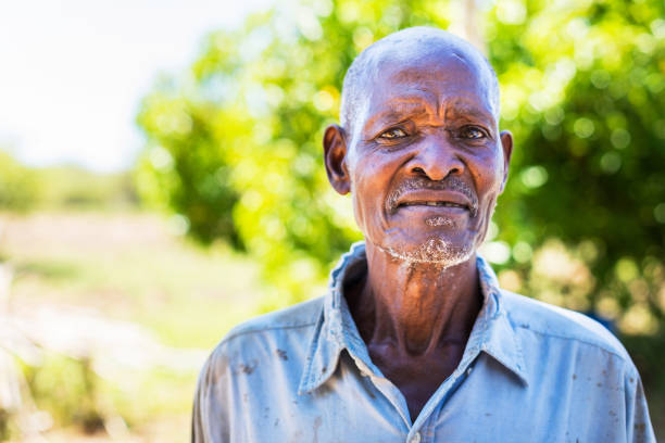 Africa, Senior Adult, Farmer - An old man looking at the camera for a portrait