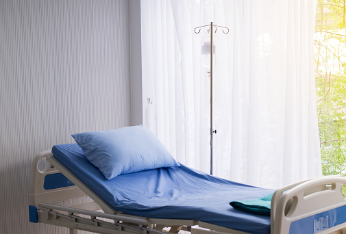 Empty sick bed at hospital room for supporting patients