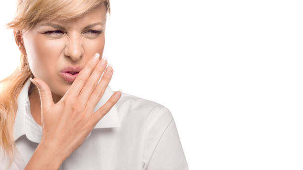 Beautiful Woman Covering Her Mouth and nose. Bad smell. Isolate on white background stock photo