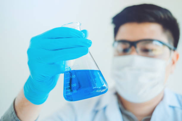 istock Scientist with equipment holding tools during scientific experiment science concept 1154521527