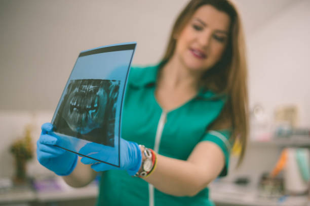 istock Dentist and female patient looking to x-ray 1154528864