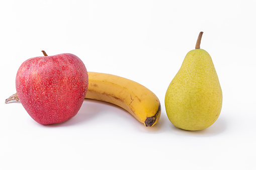 three types of fruits in a beautiful composition: apple, pear and banana on White background