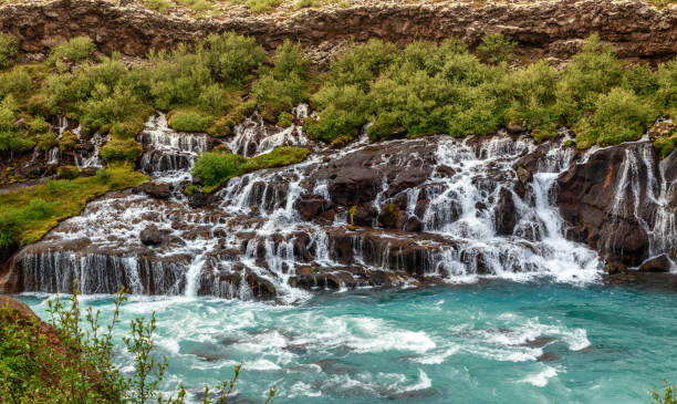 istock Hraunfossar waterfall powerful streams falling into Hvita river turquoise waters, Husafell, Western Iceland 1154536978