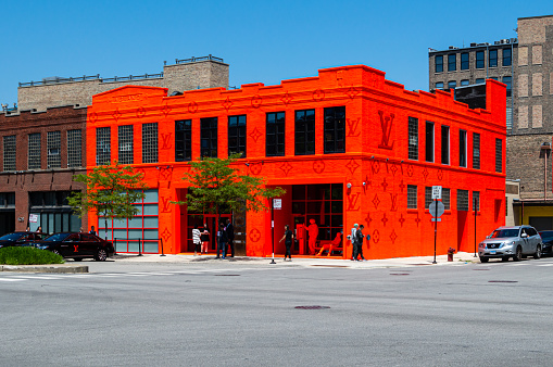 West Loop, Chicago-June 7, 2019: A Louis Vuitton pop-up retail store on the Near West Side of the city has arrived in neon orange.