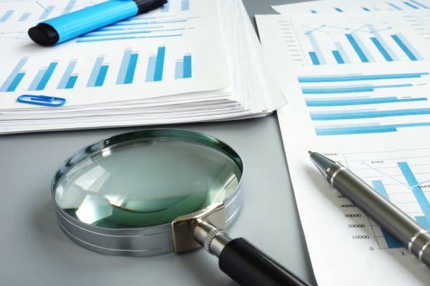 istock Magnifying glass and business report for auditing. 1154537206