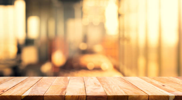 Wood table top (Bar) with blur light bokeh in dark night cafe,restaurant