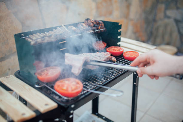 istock Man grilling meat chops on barbecue 1154539706