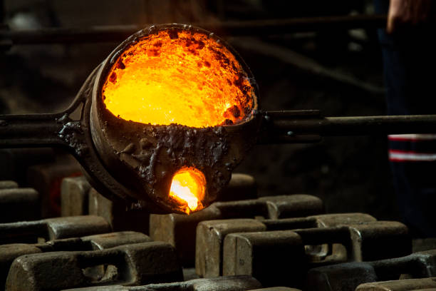 istock metal casting process with red high temperature fire in metal part factory 1154540428