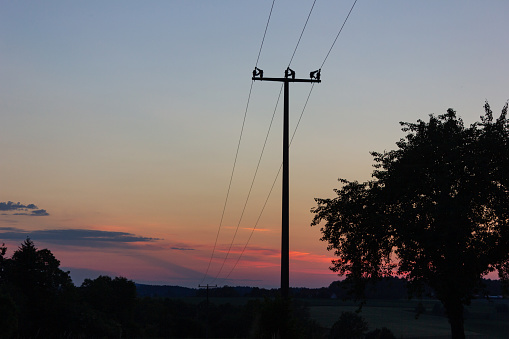 telegraph pole at colorful sunset in south germany