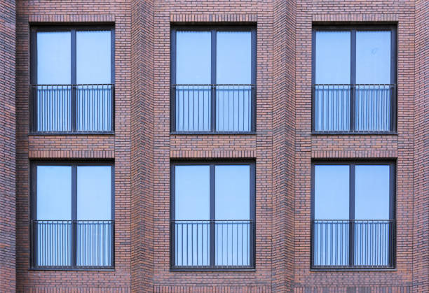 istock Residential building in loft style. Large Windows in a red brick wall. 1154540683