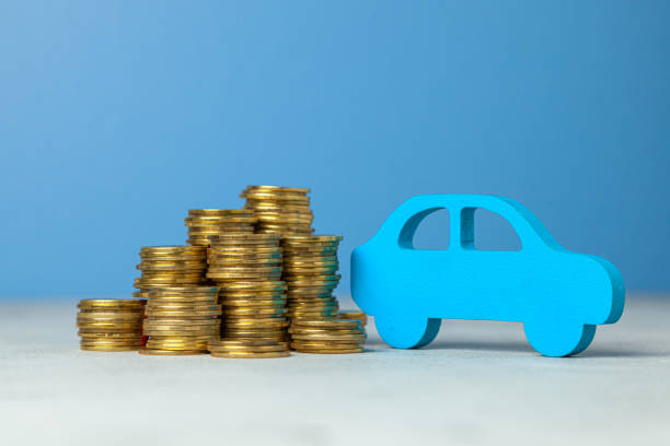 istock Car and a stack of coins. Concept car purchase or insurance. Blue background. 1154542798