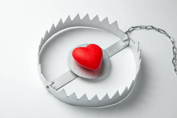 istock Trap with heart. Love is like bait. Gray background. 1154543592