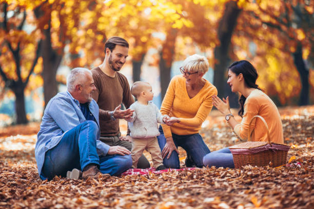 istock Multl generation family in autumn park having fun 1154546754
