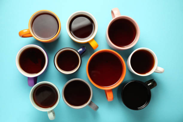 istock Black tea (coffee) in bright cups, office break, team building 1154552584