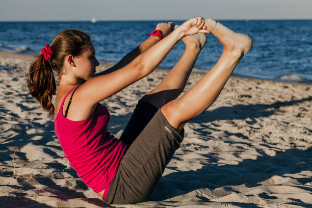 attractive student doing gymnastics by sea - 11262 imagens e fotografias de stock