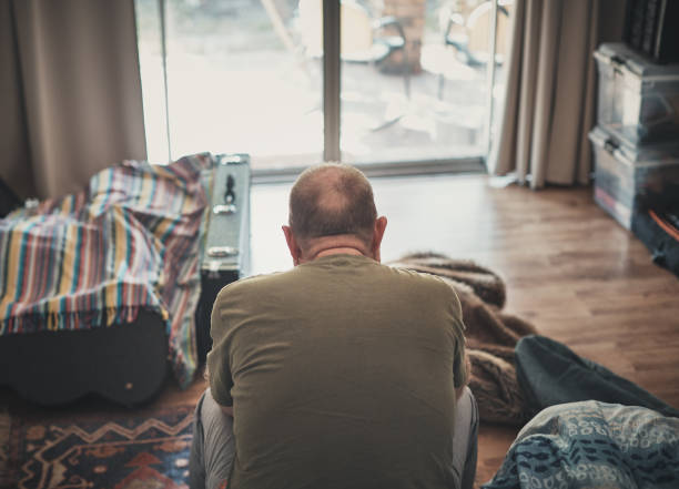 Stressed or depressed middle-aged man bows his head in despair Unhappy man considers his miserable life. divorcee stock pictures, royalty-free photos & images