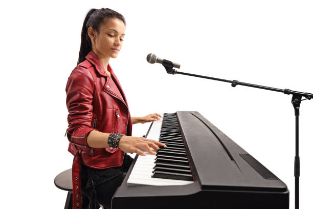istock Beautiful female young artist playing a keyboard 1154560646