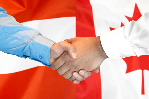 istock handshake on Austria and Canada flag background. 1154561395