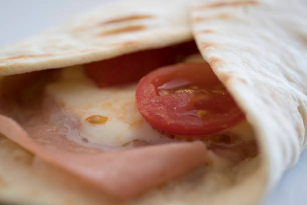 istock Italian piadina with mortadella, cherry tomatoes and mozzarella cheese 1154562478