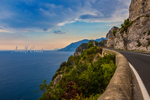 Beautiful view of Amalfi Coast from the road with colorfull sky and on the right the road to Positano