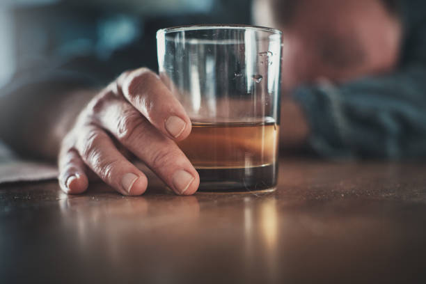 istock Troubled middle-aged man drowns his sorrows in alcohol 1154562582
