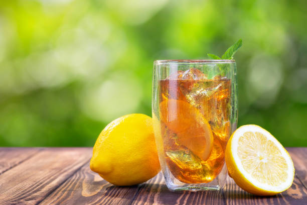 istock glass of ice tea on wooden table 1154562802