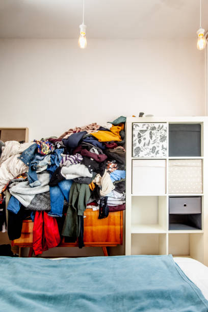 istock Stack of Clothes on a Bedroom Furniture 1154563856