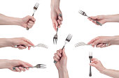 hand holding a silver fork on an isolated white background. Multiple image.