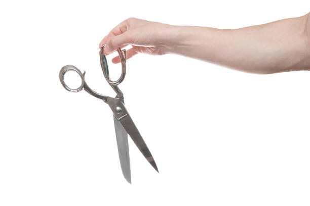 istock Hand holding big steel scissors, industrial tool, isolated on white background 1154567325