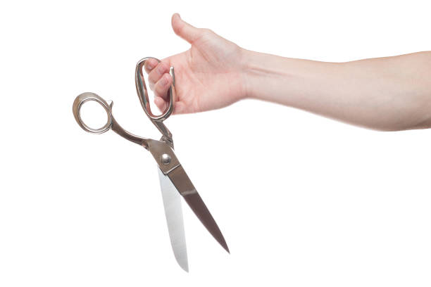 istock Hand holding big steel scissors, industrial tool, isolated on white background 1154567833