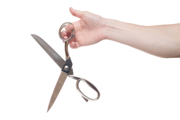 istock Hand holding big steel scissors, industrial tool, isolated on white background 1154567843