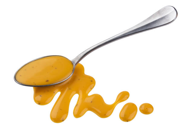 istock Mustard sauce, honey salad dressing with spoon isolated on white background, top view 1154568365