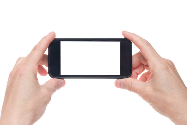 istock Hand holding black Smartphone with blank screen on white backgroun. 1154569454