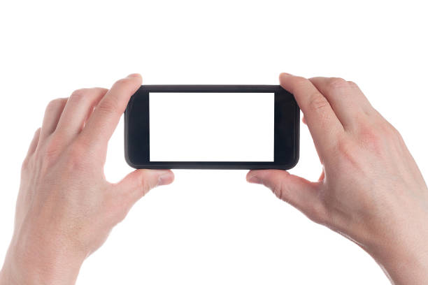 istock Hand holding black Smartphone with blank screen on white backgroun. 1154569455