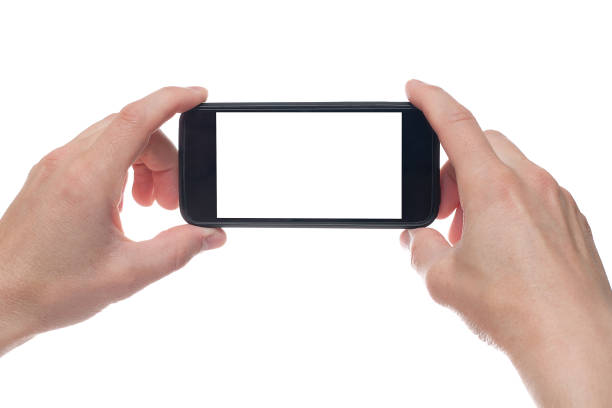 istock Hand holding black Smartphone with blank screen on white backgroun. 1154569469