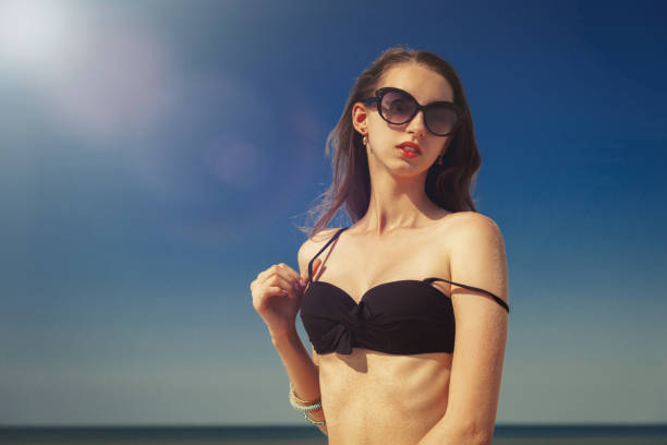istock beautiful woman tanning 1154570660