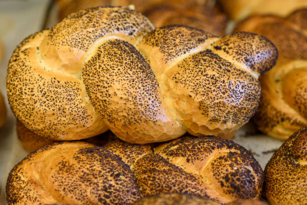 istock Breads and baked goods close-up. Fresh challah bread for shabbat. Bakery bread bun background. 1154573167