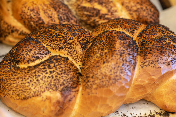 istock Breads and baked goods close-up. Fresh challah bread for shabbat. Bakery bread bun background. 1154573199
