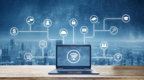 Photo of Computer laptop on wooden desk with wireless and application programming and social media icons. Internet networking and wireless technology