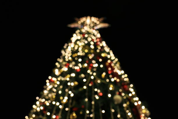 istock Blurred Christmas tree decoration background with night lights, Christmas holiday celebration, Christmas trees, a new European winter 1154577852