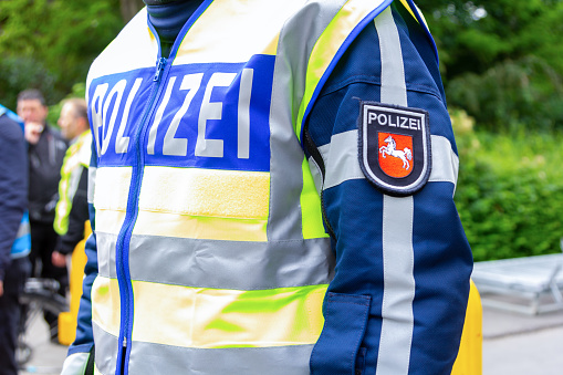 German police emblem weared by an officer. The german word Polizei, means police.