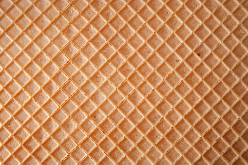 Dessert making concept with full frame macro close up on the detail texture of a wafer with copy space