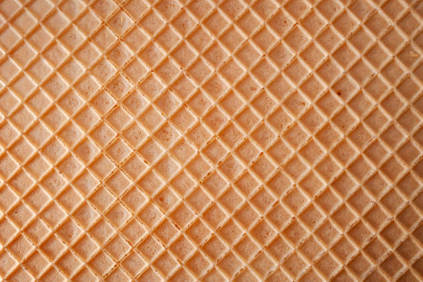 dessert making concept with full frame macro close up on the detail texture of a wafer with copyspace - waffle imagens e fotografias de stock