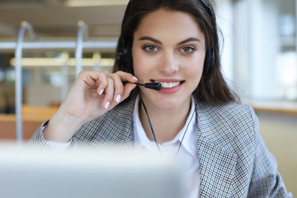 istock Woman customer support operator with headset and smiling. 1154579998