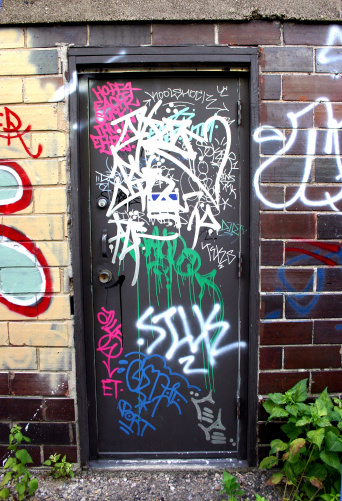 This door is laden with Minneapolis graffiti. Check it!