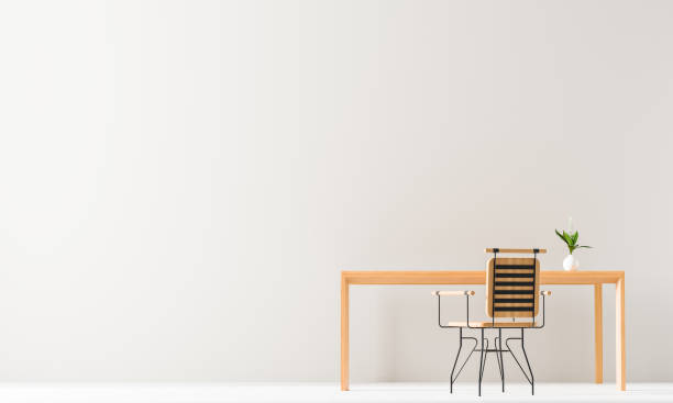 istock Minimalist workspace design with wooden table and chair. Empty wall mock up in minimal interior design concept. 3D illustration. 1154581107